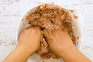 Mezclando trigo y carne con las manos