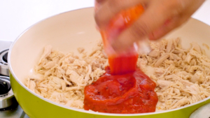 Agregando salsa de tomate al pollo