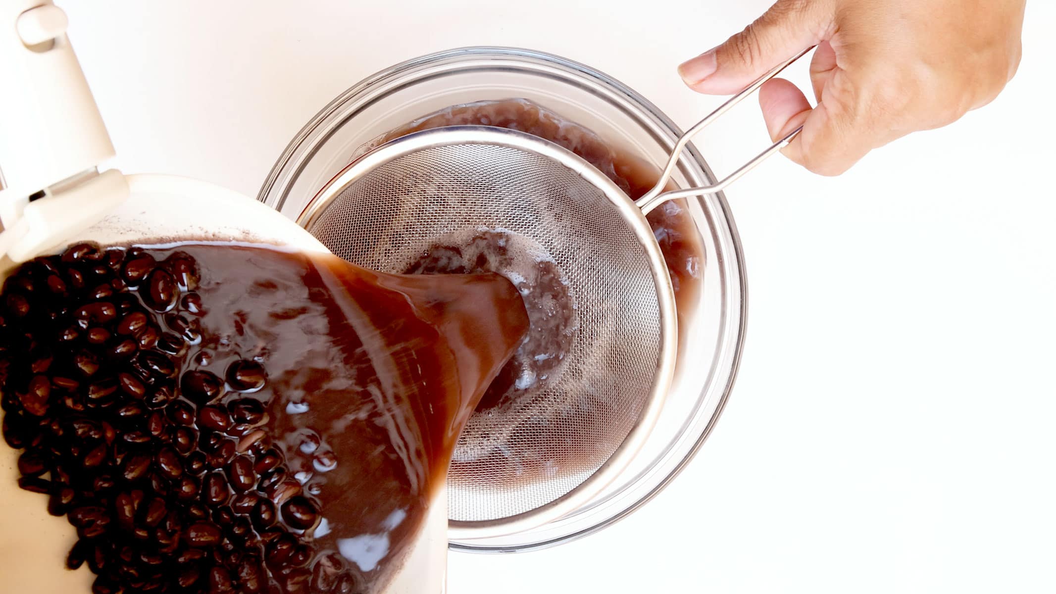 Separando habichuelas negras del liquido.